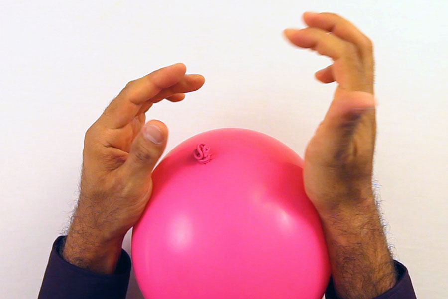 Squeeze balloons to pop